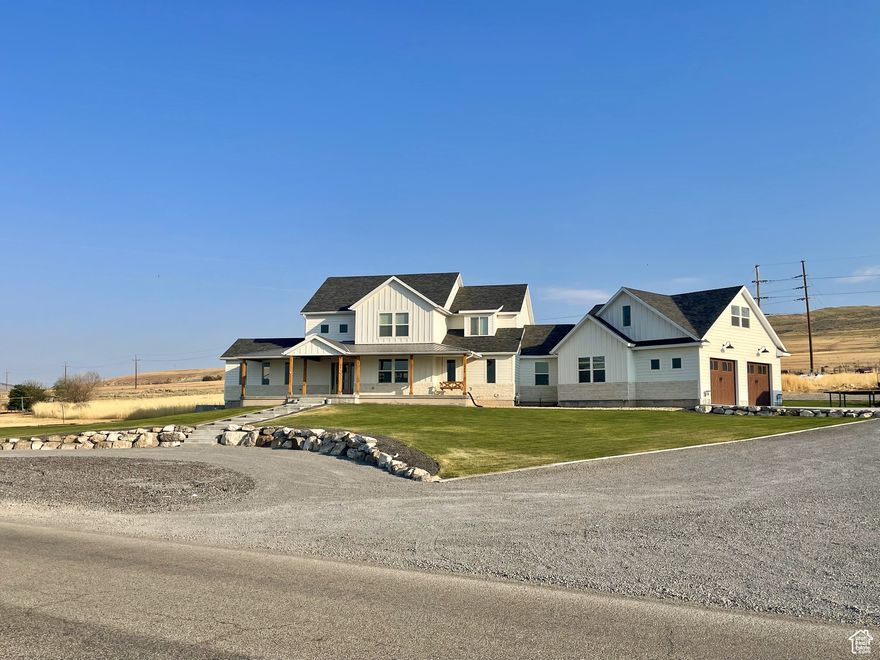 WELCOME TO YOUR MODERN FARMHOUSE, with stunning valley views! Located in Tremonton, UT. Freeway access is less than 5 minutes to both I-15 & I-84, only a 30 minute drive to Logan or Ogden, which makes country living an easy commute away! Fully finished home! Open concept living on the main floor with an 18 ft ceiling, an extra large fireplace fully rocked to the ceiling, and a 6 ft windmill fan. Vaulted sitting room with windows on all 3 sides to enjoy the views and natural lighting. Shiplap coverings and wood accents throughout the entire home. Relax and enjoy the vaulted master suite with a fireplace! Master bath boasts a large walk-in, double shower, a free standing soaker tub, and a HUGE walk-in closet! The upstairs features bedrooms with beautiful views! In the basement you'll walk into a large family room with a theatre, wet bar, and more wood and brick accents! Walk-in closets in the basement bedrooms, a walk out basement access, and plenty of storage in the vast storage room. A 500 sq ft mother in law apartment or VRBO rental is located above the garage, with its own separate exterior entrance! Situated on 1.43 acres with a 30x50 shop, an abundance of storage on a 200 sq ft mezzanine inside the shop as well as a 200 sq ft finished gym! Come and see all the custom upgrades this home has to offer! Buyer to verify all information.