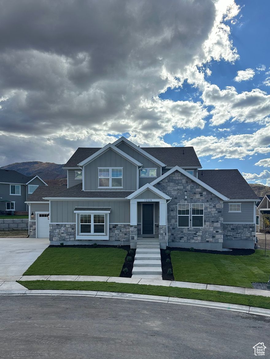 This beautiful master-on-main home is a true masterpiece, designed with both comfort and elegance in mind. As you step inside, you'll be greeted by a spacious, open-to-below family room, bathed in natural light from expansive windows. The room is anchored by a grand fireplace that stretches all the way to the ceiling, adding warmth and a touch of grandeur. A ceiling fan enhances airflow, adding to the sense of openness. The chef's kitchen is nothing short of spectacular, featuring sleek quartz countertops and top-of-the-line Z-Line appliances. A double cabinet panel fridge/freezer, large 6-burner range, and custom cabinet hood make this kitchen as functional as it is stylish. Whether you're cooking, entertaining, or enjoying family meals, there's ample space for it all. The private master suite is a serene retreat, offering a spacious bedroom and a luxurious spa-like bath. The master bath features a freestanding tub, custom tile shower, and a large double-sink vanity creating the perfect environment to relax and unwind. The master closet presents an attached private laundry room, with an additional laundry room located upstairs for added convenience. Every detail in this home has been thoughtfully designed to create a living space that's both beautiful and practical. The unfinished basement offers additional potential for customization, providing ample room for future growth.
