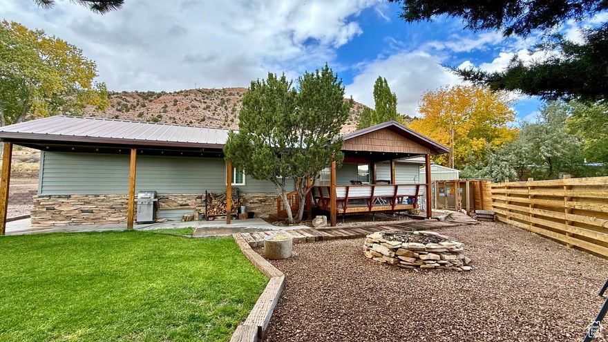 Turn Key ! A perfect place to call home, a family vacation getaway, or an Airbnb investment. This gem has been fully remodeled and is ready for new owners. It features 2 bedrooms and an additional den that can be converted into a third bedroom - currently used as a 3rd bedroom with bunk beds. Cozy up next to the wood-burning stove in this stylish yet inviting, fully furnished home. The property comes with all like-new stainless steel appliances, including a side-by-side refrigerator with a water and ice maker, a gas stove, a microwave, and a dishwasher. Knotty Alder cabinets enhance both the kitchen and bathroom. The home is equipped with a wood-burning stove and a wall heater. It also comes with an attachable A/C window unit. However, with its ample windows, the home receives plenty of natural light and benefits from a refreshing breeze. This property is completely furnished, with all furniture in like-new condition and featuring updated styles and colors. Additionally, the seller is including a trailer that sleeps 4-6 people at no extra cost (transferred via bill of sale and sold as-is). The lot has enough space for a large garage to store your boat, trailer, and other recreational toys. Enjoy the nearby town of Manila, which offers everything you need for small-town living. Flaming Gorge and the boat launch are just 15-20 minutes away, along with nearby swimming beaches. Manila also features a local gas station, rodeo grounds, and grocery store. The town is well-known for its fishing tournaments, marina, and rodeos. Note: Seller has two boats for sale - if interested, ask the agent for more details. (Agent has an interest in the ownership of the property)