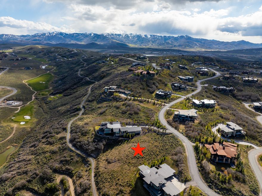 Quietly tucked into Promontory's Aspen Camp neighborhood, this 1.14-acre homesite offers a peaceful setting with expansive views over a valley, open space, the Jack Nicklaus Painted Valley Golf Course, and the mountains beyond. The gentle downhill slope provides an excellent opportunity to design a custom home that captures natural light, privacy, and sweeping scenery. A rare chance to build in one of the more serene and private areas of Promontory.