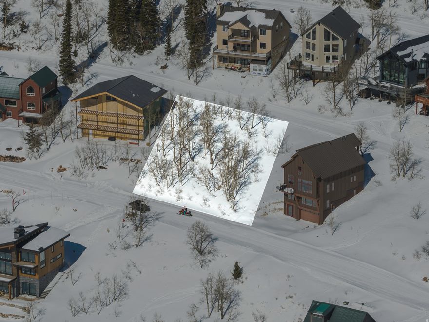 This premier building lot at Powder Mountain Ski Resort offers unparalleled ski-in/ski-out access directly from the Slow Poke ski trail, located on a relatively level parcel ideal for constructing your dream residence within the exclusive gated community of Powder Mountain West. Furthermore, it provides immediate access to an extensive network of hiking and mountain biking trails for your summer recreational pursuits.