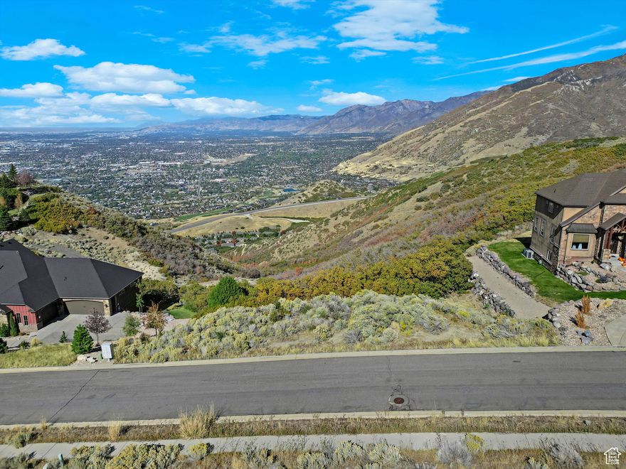 Experience luxurious, peaceful mountain living with breathtaking, million-dollar panoramic views of the Salt Lake Valley and the majestic Utah mountains. This rare 0.90-acre lot is perfectly nestled between two stunning homes in the highly sought-after Suncrest community. It's one of the last remaining unobstructed view lots-an ideal canvas to build your custom dream home with the builder of your choice. Perched at the top of the mountain, you'll enjoy direct access to endless hiking and biking trails, all while being just minutes from downtown Draper and the thriving Silicon Slopes tech hub in Lehi. As part of the Suncrest master-planned community, you'll also enjoy exclusive amenities including scenic trails, a community pool, basketball courts, and a fully equipped fitness center. Don't miss this opportunity to own a slice of mountain paradise-where luxury meets adventure. Square footage figures are provided as a courtesy estimate only, buyer is advised to obtain an independent measurement and verify all information.