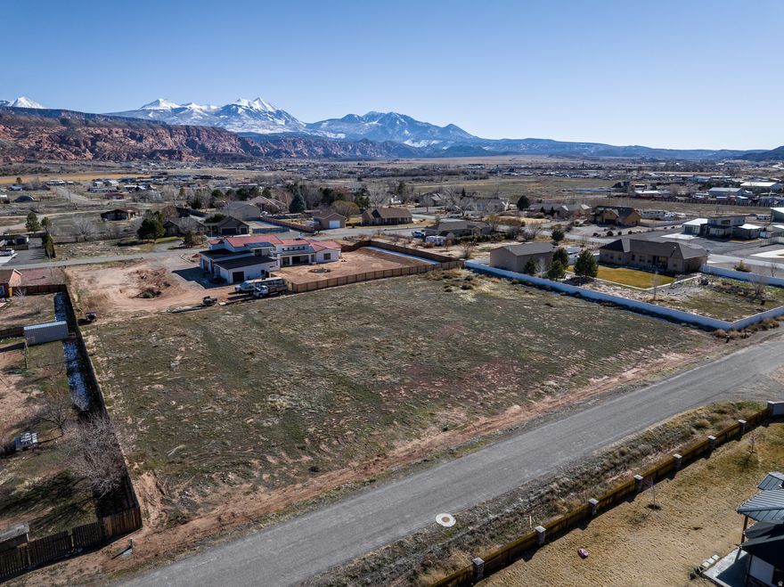 SPACIOUS BUILDING SITE - Tremendous 1.43-acre ready-to-build lot located in the desirable Estrella Estates subdivision. This homesite offers ample room for a custom residence, outdoor living spaces, additional garages or shops, and privacy. Enjoy sweeping panoramic views of the La Sal Mountains and Moab Rim, with wide-open surroundings in an established neighborhood. A great opportunity to build in southern Moab valley offering a generous canvas, vast with possibilities for your dream home!