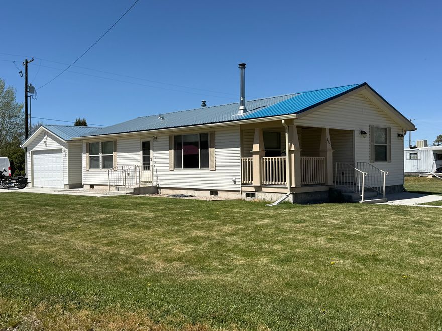 Look at this charming three bedroom, two bath home nestled in a quiet rural Idaho setting. Situated on a spacious lot, this property offers the perfect blend of peaceful country living with room to grow, relax, and enjoy the surrounding open landscape. The home features a functional single level layout with a bright and inviting living area, ideal for gathering with family or entertaining guests. The kitchen offers ample cabinet space and flows comfortably into the family room, creating a warm and practical everyday living space. The primary bedroom includes its own private bathroom, while two additional bedrooms provide flexibility for family, guests, or a home office. Large windows throughout the home bring in natural light and showcase the wide open views that make rural living so desirable. In addition to the home, the property includes a fully finished shop, complete with a concrete floor, power, sheetrock, making it ideal for a workshop, storage, hobbies, or a home-based business. Outside, you'll find a detached garage, a generous driveway, and plenty of space for RV parking, outdoor projects, or recreational vehicles. The expansive yard offers endless possibilities, whether you're dreaming of a garden, additional outbuildings, or simply enjoying the quiet surroundings and fresh Idaho air. With its peaceful location, mountain views, and room to breathe, this property is a great opportunity for those looking to enjoy a slower pace of life while still being within a reasonable distance to nearby towns and amenities.  Come experience the space, privacy, and versatility this rural Idaho property has to offer.