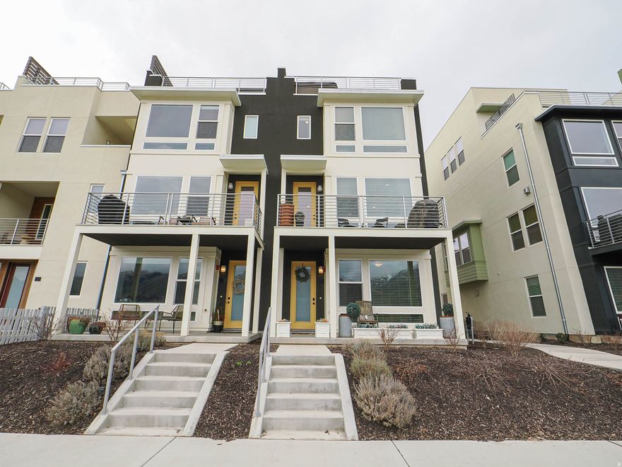 RISE above the ordinary in this exceptional four-story end-unit townhome, where light, views, and design come together beautifully. Soaring ceilings and expansive windows flood the home with natural light and frame breathtaking views of the Wasatch Front. The thoughtfully designed layout offers four spacious bedrooms - including two with private ensuite baths - creating the perfect balance of comfort and privacy. DESIGNED for both elevated entertaining and everyday living, the top-level skyroom opens to a private rooftop deck complete with a hot tub - your own personal retreat under the Utah sky. LOCATED in the heart of beloved Farmington, you're just steps from Station Park's premier shopping and dining, with a newly built city park nearby featuring pickleball courts and a way beyond average playground. Whether it's morning coffee with mountain views, starlit soaks on the rooftop, or a quick stroll to dinner, this location delivers. End unit. Two-car garage. Built in 2024. MODERN LUXURY, PERFECTLY POSITIONED.