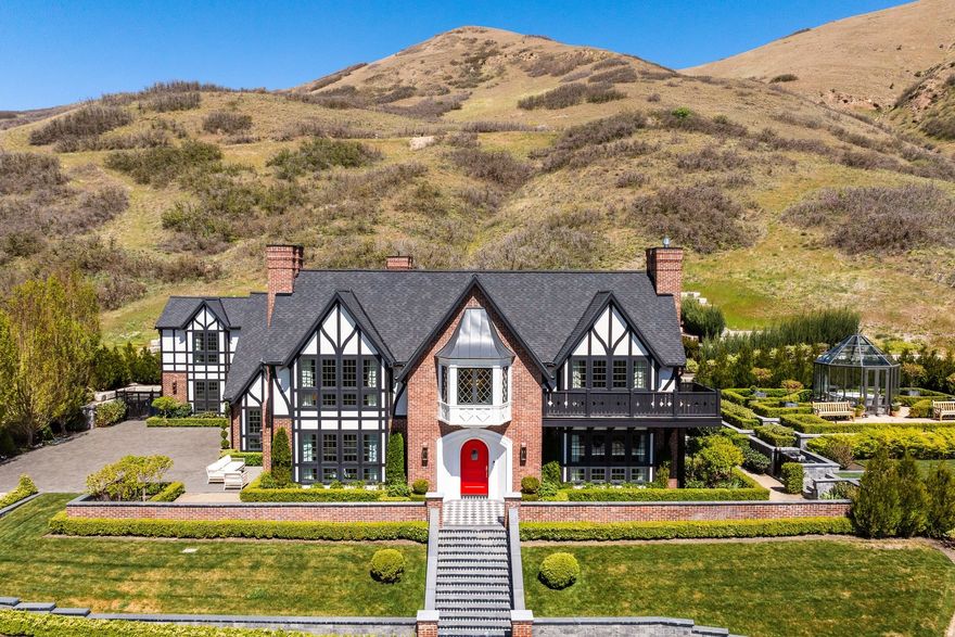 Nestled within the prestigious, gated North Cove community - complete with 24/7 security - this exceptional estate offers refined luxury living on 3.36 acres of beautifully landscaped grounds.  Enjoy breathtaking views, a private swimming pool with patio and an additional patio overlooking the valley, featuring a fully enclosed glass atrium, an idyllic setting for outdoor dining. Heated driveway ensures effortless access in every season and leads to a spacious, attached two car garage.  Inside, the home reveals a stunning, thoughtfully curated interior.  A grand entry makes a striking first impression with hand painted mural wallpaper and a sweeping staircase that sets an elegant tone throughout. The formal dining room and inviting family room each showcase gas fireplaces with intricate mantels, creating warm yet sophisticated gathering spaces.  The custom, gourmet eat in kitchen is a chef's dream, appointed with a L'Atelier Paris gas range, generous prep space, and a charming dining nook featuring custom walnut-stained table and bench.  A well-equipped butler's pantry offers a La Cornue range, Jennair microwave, custom cabinets for additional storage and an open pantry space.  The main level is completed by a cozy den, powder bath, and functional mudroom. Upstairs, the luxurious primary suite captures sweeping Wasatch Mountain views and features vaulted ceilings, a private patio, gas fireplace, spacious walk-in closet, and an expansive en-suite bath with dual vanities, an oversized shower, and a soaking tub. Three additional bedrooms - including one en-suite with captivating views, a full bathroom, and a large laundry room with built-in-cabinetry and ample counter space complete the upper level. Designed for both entertaining and versatility, the lower level includes a home theater with bar seating, a guest bathroom, and an impressive 1,000 square foot custom closet with built-ins and tailored cabinetry.  A bonus room offers ideal space for a game room or home office. Enhancing the property's flexibility is a three-level accessory dwelling unit, complete with a workout room, full kitchenette, bedroom, and 3/4 bathroom-perfect for guests, extended family, or private living quarters. All information herein is deemed reliable but is not guaranteed. Buyer is responsible to verify all listing information, including square feet/acreage, to buyer's own satisfaction.