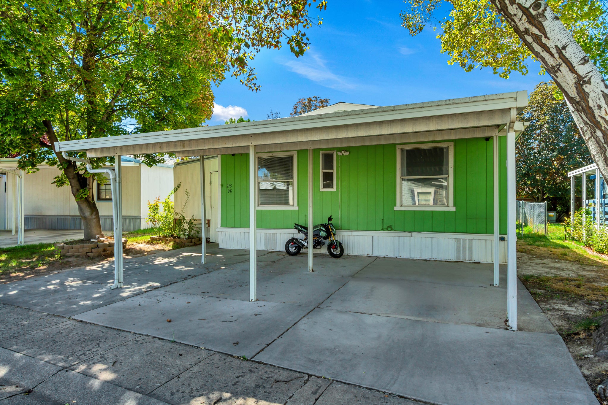 Attached carport with a concrete pad