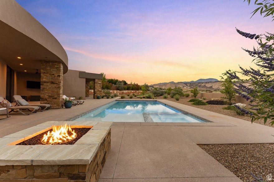On the golf course, with a backyard oasis including a pool, putting green, fire pit and more. This 2022 build was thoughtfully designed with a built-in wired speaker system connecting the great room, patio, and dining areas. A tech cabinet controls audio, automatic shades, and Wi-Fi boosters, with room to expand for a full smart home setup. Luxury upgrades include a Hide-a-Hose central vac system, tankless water heaters with recirculation pumps, Low-E thermal break windows, 2x6 exterior & wet wall construction, solid cherry inset cabinetry, a smart appliance package, garage storage enhancements, and laundry hookups in the primary closet.