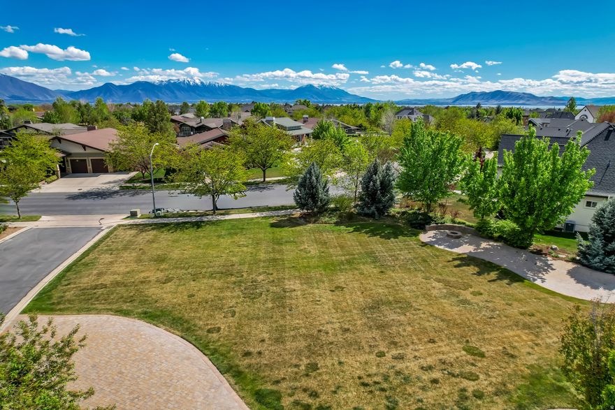 Tucked within the highly desirable Grandview neighborhood, this premier lot sits on a quiet cul-de-sac. Directly across the street from the community clubhouse, the location adds both convenience and lifestyle-putting neighborhood amenities just steps from your front door. Surrounded by well-kept homes and natural beauty, the setting feels both elevated and peaceful, an ideal canvas to bring your vision to life on one of the last buildable lots within the community. This lot not only provides endless possibilities to build your dream home, but also the convenience of being just minutes from shopping, restaurants, I-15, BYU, UVU, & Utah Valley Hospital. House plans available upon request. Buyer/Buyers to verify all information.