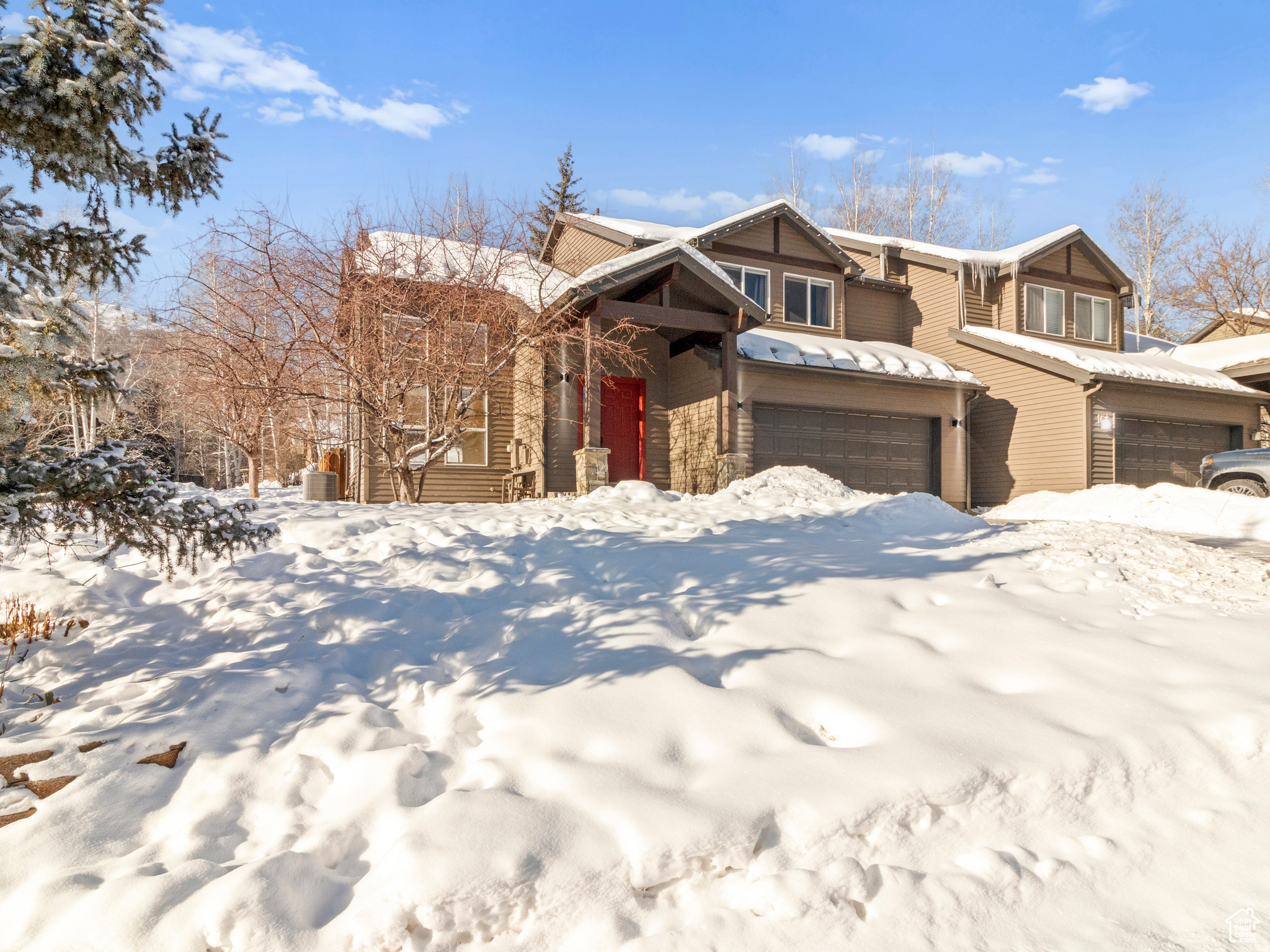 This affordable contemporary mountain townhome offers a spacious natural light filled floor plan: three levels, 5 bedrooms, 4 bathrooms.  It invites you in with main level entertaining, a 22 foot vaulted ceiling in first of two living spaces and two egresses to the fenced back yard with hot tub. The mud room, laundry room, and oversized two car garage provide ample storage space.  Going upstairs to a primary bedroom bathroom suite, two additional bedrooms and one additional bathroom, and a lofted flex space with surrounding mountain views. Downstairs is a finished basement with a large rec room and storage closet, and two more bedrooms and one bathroom. Unique property tranquility on sheltered street with open space to the south designated as sanctuary easement. Whether it's living, vacationing, or investing, this home is versatile.  Nestled in the Horsethief Canyon neighborhood of lower Pinebrook it's close to fun: scenic trails and slopes, shopping, dining, and all Park City has to offer! Prime location commute times: 3 minutes to Woodward or Kimball Junction, 10 minutes to Canyons Village, 20 minutes to Historic Main Street, Park City Resort, and Deer Valley, and just 30 minutes to Salt Lake City Airport.