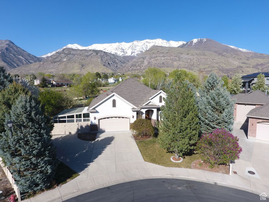 OPEN HOUSE 12-2PM Saturday May 3rd. See the 3D virtual tour! Beautiful home with the most amazing backyard waterfall you will have ever seen at a home. This home features a separate mother-in-law basement that could easily be converted into a rental space or AirBnB. **Special Features** Hard wood premium flooring on first floor. Master bedroom has exterior walkout doors to backyard. Master bath starts in hallway with walk-in closets on both sides. Also includes a wide open bathroom with sinks and a big jetted tub. Separate from the tub is a tile shower. The kitchen is luxury with double stacked ovens and Santa Cecilia granite countertops. The backyard is completely landscaped with a waterfall system and stream - ($80k in improvements in 2008 when originally put in, which holds a lot more in value today).  Stone walkway up and down yard with a beautiful view of the mountains as backdrop. Backyard has forestry and fruit trees. On the side of the house is an added sunroom with a very nice included hot tub that hasn't been used. The exterior door on the other side of the house opens into basement mother in law apartment with a kitchen, big family room, 3 bedrooms, and 2 full bathrooms. One of the basement bathrooms is equipped with a $14k Safestep accessibility/disability bath improvement. additional slice shaped parcel of land over fence line is also owned. The home is easy to show. Come and see this original and beautiful home today!