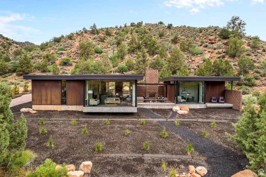 Desert modern architecture by award-winning Imbue Design meets the grandeur of Zion National Park in the Watchman Steel House. A striking exterior of rusting weathering steel blends effortlessly into the iron-rich landscape. The understated home boasts sandstone views that rival those from within the Park. A back patio provides a change of scenery and color with a hillside of conifers as backdrop. It is a quiet place to unwind, immerse in a good book or enjoy a warm soak after a day of hiking. Morning yoga is sublime. Or simply relax with your coffee and marvel at changing shadows cast across the West Temple by the rising sun in the east. Cozy and warm interior design is complemented by distinctive and beautiful Navajo furnishings. Predominately neutral tones inside allow the vibrant hues of the landscape to shine. A one bedroom casita has full kitchen and bath: you are able to host lucky family and friends while allowing downtime and privacy for all. Guests also have a small private patio and the premiere sunset views on Watchman Mountain. This is a one-of-a-kind property defying ordinary comparisons. A family vacation home for the generations, we welcome you for a visit to experience and to fully appreciate this special retreat.