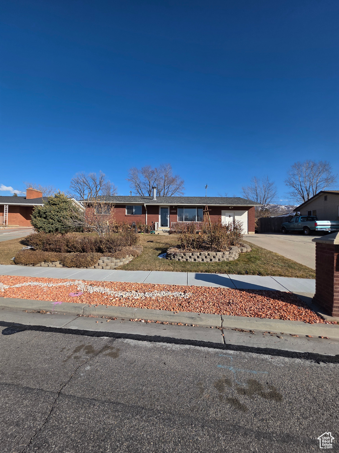 Nestled in a quiet and friendly neighborhood, this inviting 5-bedroom, 2-bathroom Ranch-style home offers comfort and convenience. Built in 1963, the home showcases a timeless design with a spacious open floor plan, perfect for both everyday living and entertaining.  The main living areas are filled with natural light, creating a warm and welcoming atmosphere. The large windows throughout the home provide scenic views of the surrounding neighborhood and a sense of openness. The well-appointed kitchen provides ample space for cooking, and the living and dining areas offer great flow for family gatherings.  With a generous 0.25-acre lot, there's plenty of outdoor space for enjoying the fresh air, gardening, or just relaxing. The home is situated in a prime location, offering easy access to local amenities, schools, and major highways.  Perfect for families or anyone looking for a cozy, yet spacious home, this property blends comfort, style, and practicality. Don't miss your chance to own this wonderful home in the heart of Woods Cross!  Square footage figures are provided as a courtesy estimate only and were obtained from Tax Data.  Buyer is advised to obtain an independent measurement.