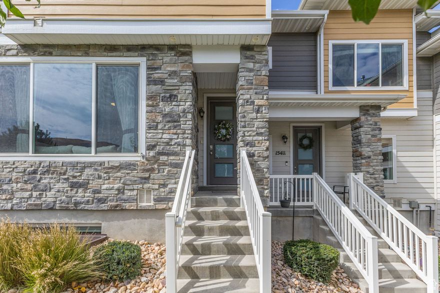 Step inside this beautifully cared for Bluffdale townhome that feels like new. Thoughtfully upgraded throughout, it combines modern comfort with timeless design.  The heart of the home is the fully remodeled kitchen, complete with sleek quartz countertops, custom slow close cabinetry and drawers, high-end finishes, and all new appliances. Just off the kitchen, the open living area features soaring ceilings and a custom wall-mounted fireplace and entertainment center, creating the perfect space to gather or unwind.  Upstairs, you'll find three bedrooms including a spacious primary suite with granite finishes and a luxurious rain shower. A fourth bedroom on the lower level offers an en suite bathroom and walk-in closet ideal for guests or multi-generational living.  The garage is as impressive as the interior, finished with epoxy floors, fresh paint, upgraded stairs and handrails, and two mounted storage racks, storage is never a problem. Additional upgrades include a tankless water heater, whole-home water softener, and dedicated filtered drinking water at both the sink and fridge.  Outside, enjoy stunning mountain views and access to neighborhood amenities including a swimming pool, splash pad, playground, and pickleball court. Internet is also included as part of the community.  Location Highlights: Quiet, safe community with multiple parks within walking distance  Schools close by: an elementary school (K8) just across the street and the high school less than a mile away  Easy access to I-15 and Bangerter Highway for quick commuting  Just minutes to restaurants, shopping, and grocery stores  Nearby outdoor recreation with biking and hiking trails to explore  Only ~25 minutes to Salt Lake International Airport  This home is a rare find in a vibrant, family-friendly community! Don't miss the chance to make it yours.