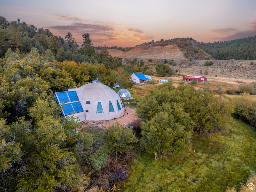 Heart Water Farm is a well-established 20+ acre sustainable homestead; designed & constructed with disaster resiliency & managed through permaculture principles with healthy ecosystems that sustain vegetation & animal life. Diversely wooded hillside forests, grazing pastures and meadows support this countryside rich with wildflowers, herbs and forage. The property includes 4.5 A/F of water rights, irrigation waterways, and a deep pond with an island & waterfalls. The Virgin River and natural creeks run throughout. The property achieves lower property taxes for grazing the land through Utah's Farmland Assessment Act (FAA), aka the "Greenbelt" law. The program allows eligible agricultural property to be taxed based on its productive value for agriculture, rather than its fair market value. The architecturally custom-built dome house operates under minimal maintenance, both passive & active solar heating, with an off grid electric system, & an artesian well for culinary water. A traditional style barn was built in 2022 making the 816 Sq Ft  garage a candidate for a quest house. Several outbuildings, greenhouses and growing ponds all landscape the property.