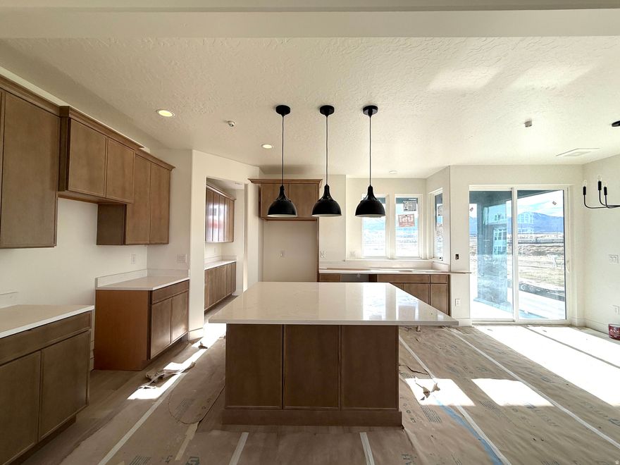 Rare Cozumel Townhome in Downtown Daybreak-Only ONE in the Community! This 3-bedroom, 2.5-bath Home with a Flex Room Sits on a Prime Corner Lot & Features a Private, Fenced-In Courtyard. The Interior Mirrors the Model Home with Upgraded Cabinets, Quartz Countertops, a Butler's Pantry, High Ceilings, Open Floor Plan, & Gas Fireplace. The Standout Sky-room & Expansive Rooftop Deck Include an Electric Fireplace, Wet Bar, & Hot-Tub-Ready Space, Ideal for Entertaining. Just a Short Walk to Downtown Daybreak Shops, Restaurants, Bees Stadium, & Future Amenities. ** This Home is at Sheetrock & Estimated Completion is April/May 2026. ** Pictures of the model home and not of actual home.