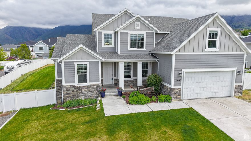 Be sure to click on the 3D Tour button for a personal walk-through tour of the home. Welcome to your serene retreat in the heart of Elk Ridge, where space, views, and thoughtful design come together on a beautifully landscaped lot. This well-maintained home features 4 spacious bedrooms, 2.5 bathrooms, and 9-foot ceilings on the main floor, creating an open, airy atmosphere throughout. Enjoy granite countertops, a stylish farm sink, laminate flooring, floor to ceiling east facing windows in great room, double ovens, and an electric cooktop - all designed for comfort and functionality. Separate tub and shower in primary bathroom, full walk-in closet. Vaulted ceilings in primary bedroom and main floor great room. The side walk-out basement offers a separate entrance with a sidewalk ramp that could accommodate wheelchair access and presents a great opportunity for a future ADU (accessory dwelling unit) or separate apartment. Facing west, the home captures stunning mountain views to the east and provides cool backyard shade in the hot summer months - perfect for relaxing under the brand-new gazebo as you enjoy the peaceful setting and valley views. House has a fire suppression system installed by the builder. Outside, it's a gardener's paradise. You'll find the following fruit trees and bushes: 4 cherry, 2 elderberry, 1 nectarine, 3 peach, 2 apple, 4 grapevines, 100 feet of raspberries, 20+ rose bushes, 23 garden beds with automatic watering systems for effortless care. This property also includes limited animal rights (buyers to verify details with the city), opening the door to a small homestead or hobby farm.  Note: Square footage figures are provided as a courtesy estimate from Utah County records. Buyers are encouraged to obtain an independent measurement.