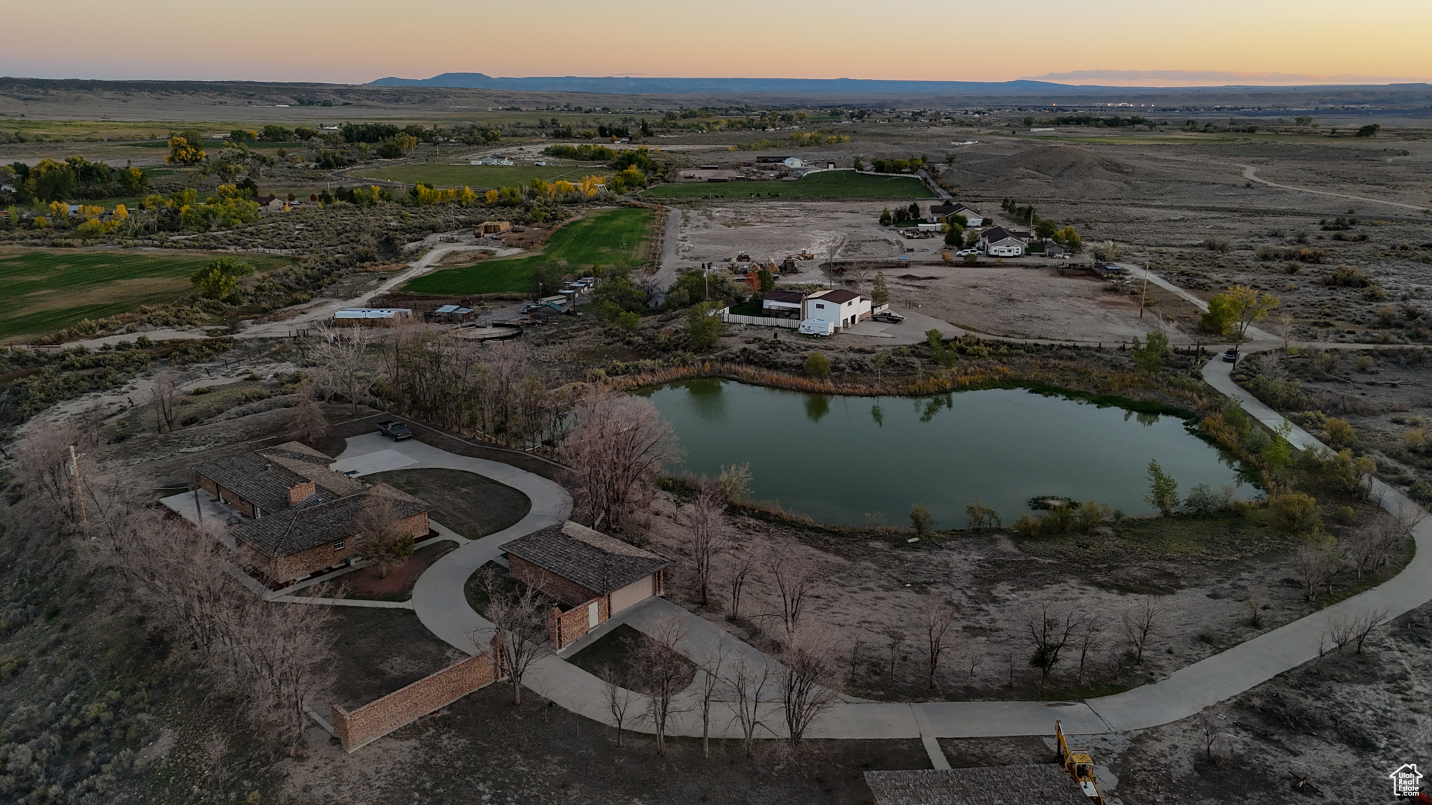 Sold As-Is. Water Shares negotiable. Experience true exclusivity on this ten-acre estate, featuring your very own private lake, over 1 acre with a depth of 15' in the middle, with a boat dock for year-round recreation including fishing and ice skating. The home's open layout and a large patio with amazing 360-degree views are perfect for entertaining, while the primary suite offers a spa-like retreat with a unique "Habitat unit" for steaming, tanning, and more! The property includes a two-car attached garage, a detached 4+ car 20x40 foot garage with 220 power, and a 36x36 foot barn with 220 power. This is a rare opportunity to own a blend of natural beauty like the Pakistani onyx marble entry with Italian marble throughout the rest of the home and other luxurious amenities