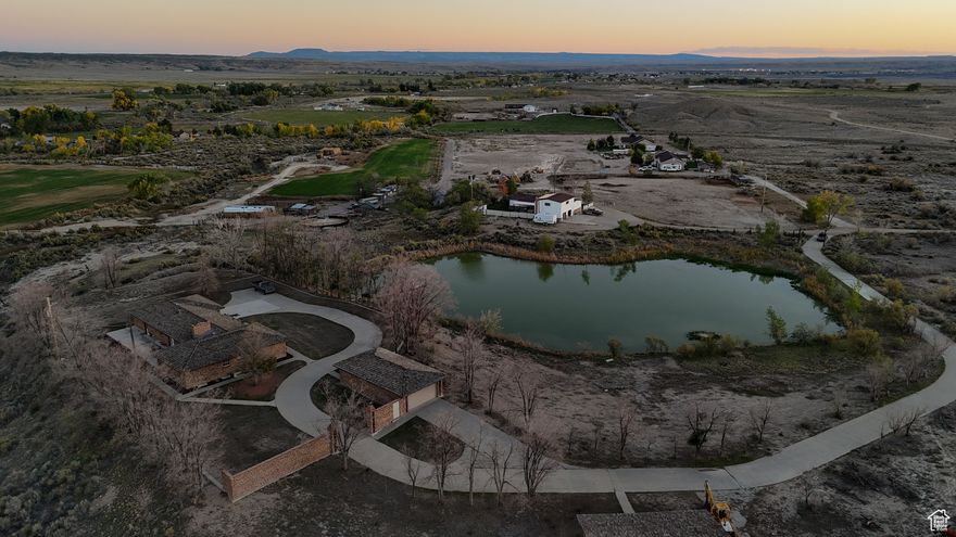 Sold As-Is. Water Shares negotiable. Experience true exclusivity on this ten-acre estate, featuring your very own private lake, over 1 acre with a depth of 15' in the middle, with a boat dock for year-round recreation including fishing and ice skating. The home's open layout and a large patio with amazing 360-degree views are perfect for entertaining, while the primary suite offers a spa-like retreat with a unique "Habitat unit" for steaming, tanning, and more! The property includes a two-car attached garage, a detached 4+ car 20x40 foot garage with 220 power, and a 36x36 foot barn with 220 power. This is a rare opportunity to own a blend of natural beauty like the Pakistani onyx marble entry with Italian marble throughout the rest of the home and other luxurious amenities