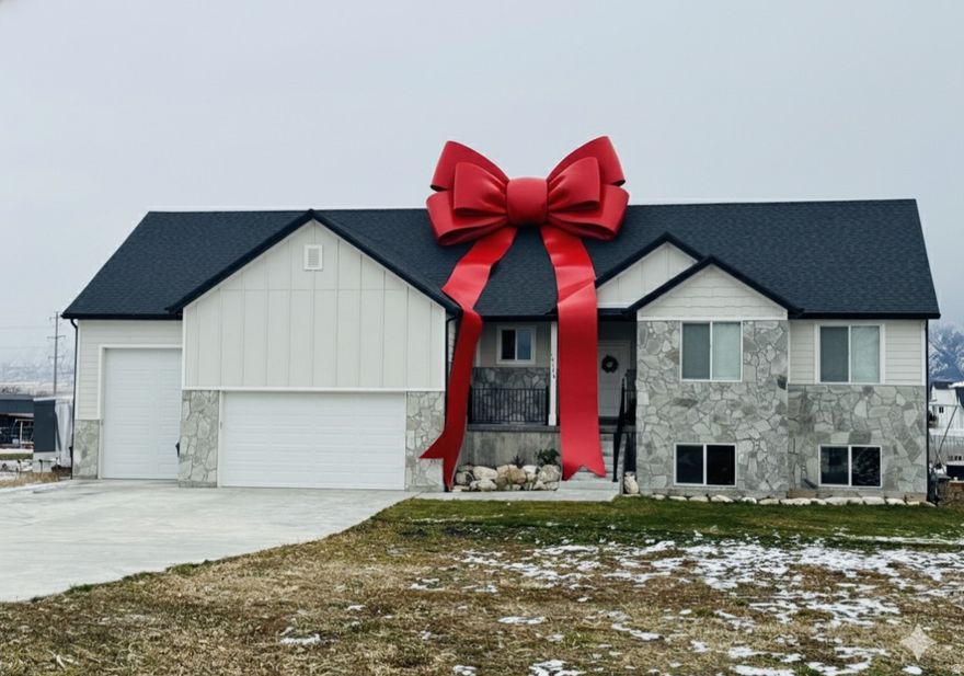 Escape the city with this beautiful home on 1.5 acres! Enjoy country views while still being less than 5 minutes from grocery stores and I-15. You'll love having no power bills for 90% of the year with a paid-in-full, whole-house solar system and battery backup. Reliable fiber internet is also run to the home. Inside, you'll find vaulted ceilings and an open layout that feels bright and inviting. Step outside of this west facing home to a spacious covered deck and large back patio. The oversized third-car garage could easily fit an RV. A separate entrance to the basement through the garage offers potential to create an ADU. The property has a large garden and orchard area with tons of open space for chickens, goats, horses, or whatever you can imagine. Includes 1 culinary water share from West Corrine Water. This home is priced to sell. Come take a look!