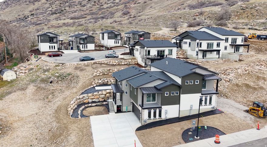 Brand new and ready for occupancy! Live high on the east bench in Ogden and enjoy this home nestled on Ogden's picturesque east bench offering the perfect blend of modern luxury and outdoor adventure. This home is custom built to boast breathtaking panoramic views and provide direct access to scenic hiking trails, inviting you to embrace the beauty of nature right outside your doorstep. Upgrades and views everywhere you look! The sleek kitchen is a chef's delight, equipped with premium appliances, stylish cabinetry and ample counter space flowing into the the main living area with tons of natural light and a bonus deck with expansive mountain and city views. A walk-in closet in the master with a separate soaking tub and balcony. Absolutely must see. Ask about special lender incentives! Luxury paired home style.