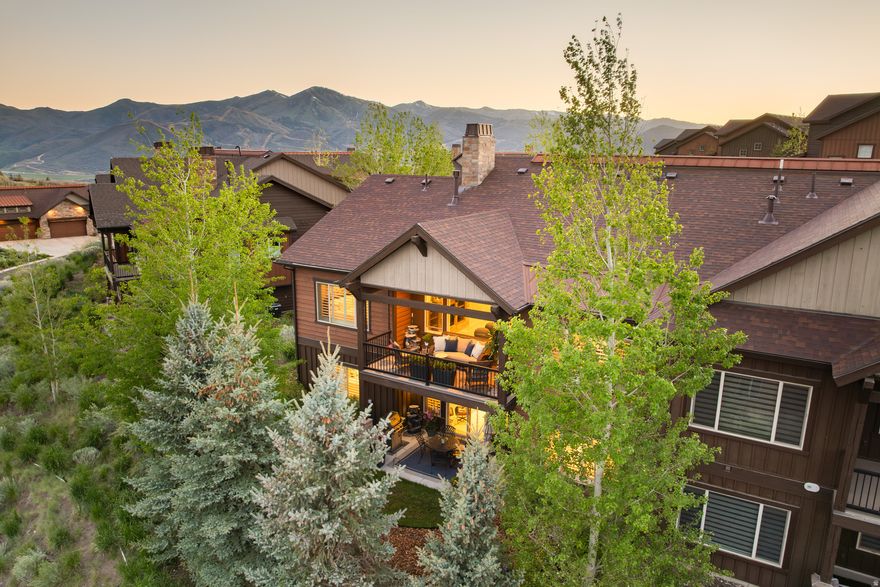 Pristine, bright, and spacious, this Rustler at Hideout residence offers easy access to the best of the greater Park City lifestyle. Built in 2017, the home features a thoughtful open floor plan with a main level primary suite, abundant natural light, and quality finishes including hardwood floors and recently updated kitchen and baths with quartzite countertops. As a twin home corner unit, it enjoys added privacy along with a light, expansive feel throughout.  The open kitchen, dining, and living area is designed for both comfortable everyday living and entertaining, with a large glass slider opening to a private deck with mountain views and seamless indoor-outdoor flow. Mature landscaping, gardens, and a private patio create additional inviting spaces to relax and unwind.  With 3 bedrooms, 3 bathrooms, two separate living areas, and a flex gym/theater room, the home offers plenty of flexibility for guests, entertaining, or full-time living. A 2-car garage, short, flat driveway, and quiet cul-de-sac location add to the privacy and convenience. Located just minutes from Deer Valley East Village, Jordanelle Reservoir, hiking and biking trails, and kayak and paddleboard launch, this home is equally well suited as a full-time residence or a four-season lock-and-leave mountain getaway.