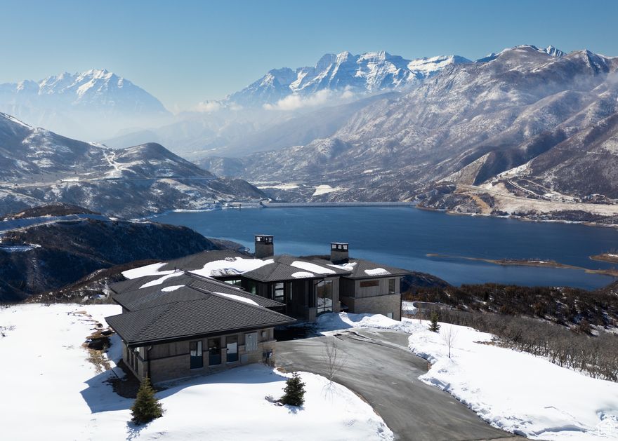 Discover unbeatable panoramic views of Deer Valley, the Jordanelle Reservoir, and Mount Timpanogos in this home designed by Otto-Walker Architects and brought to life with the distinguished craftsmanship of Germania Construction. Perched on a 0.60-acre lot in the community of Golden Eagle, the setting promises serene living and spectacular scenery year-round, with the benefit of world-class skiing and vibrant entertainment 10 miles away in historic Park City, Utah. The interior of the home celebrates the breathtaking views from nearly every corner of this residence. The great room, with vaulted ceilings and expansive windows, fills the home with natural light and maximizes the views. The interior design, finishes, custom cabinetry, and fixtures selections are by Teri Nelson and Brittney Burns Dubay The kitchen is a chef's delight, boasting top-of-the-line appliances and a large island for cooking and entertaining. The kitchen leads into a cozy hearth room, perfect for quiet mornings or intimate gatherings. The main-level primary suite is a haven of relaxation, complete with a private balcony and an ensuite that includes a soaking tub with a view. An office, laundry, and powder complete the main level. The lower level is designed for fun and relaxation, with a family room with a fireplace, wet bar, billiards, and access to an outdoor covered patio. The three additional bedroom suites ensure comfort and privacy for everyone. A powder bath & large laundry room complete this level. With the new Mayflower base area and the Jordanelle Reservoir mere minutes away, hundreds of miles of trails in your backyard, and a plethora of outdoor attractions nearby, nature recreation has never been so easy. The upcoming Market Park City grocery & Black Rock Mountain Resort will bring added convenience and amenities to the area. The proximity to the best skiing in the west, the entertainment of Park City, & the Salt Lake Int'l Airport make the location unbeatable