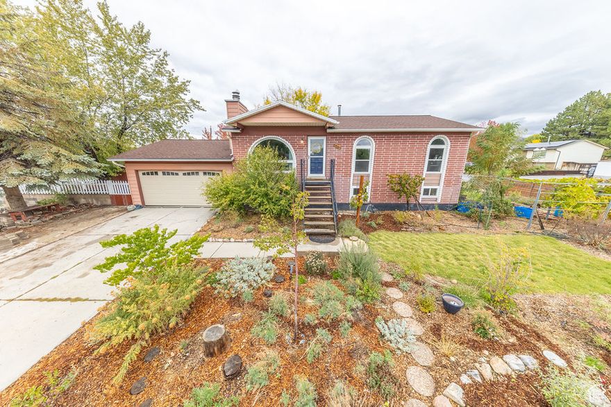 Urban homesteaders dream. Low/no water lawn with fruit trees, an almond tree, grapes, raised garden beds and room to add more. Home has new windows, a new AC unit, & a new range. The proximity to shopping, local park and the freeway make this a super convenient location. WIth 5 beds and 3 baths there's plenty of space. And the walk out basement could be converted to an ADU as well. Great home, great location! Full list of yard/garden:Almond, hazelnut, cherry, nanking cherry, pear, peach, raspberry, thornless blackberry, strawberry, goji berry, serviceberry, elderberry, currant, natives and pollinator plants, herbs. Dog Tuff grass- only needs water 1x/month, mowing optional. Square footage figures are provided as a courtesy estimate only and were obtained from a previous listing(MLS) .  Buyer is advised to obtain an independent measurement.