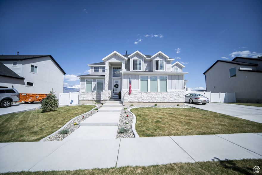 Welcome HOME to this beautiful home where modern design meets top-tier upgrades. The main floor features custom built-in shelving, upgraded lighting, and an open-concept layout perfect for entertaining and enjoying the amazing views of Utah Lake and the Wasatch Mountains. Enjoy the counter depth refrigerator, elegant hardware (no more builder grade stuff..) and designer light fixtures. A dedicated office with built-in bookshelves offers a quiet retreat for work or study. Throughout the whole home, you have motorized blinds that are rechargeable! Upstairs you have spacious bedrooms and tons of space. The primary suite boasts enhanced lighting and fixtures for a spa-like experience, all bedrooms have plenty of light, and include ceiling fans. The walkout basement is where this home really shines! It is a true showstopper, featuring a complete in-law suite with a full second kitchen, large bedroom, private laundry, and a high-end bathroom with a three-head shower and infrared sauna. Beyond that you have an amazing home FULLY CUSTOM home theater with built-in Dolby Atmos 11.2 surround sound and reclining seats, and just wait until you see the fully finished safe room - fire rated and can be used as a safe room too. The heated and cooled garage is fully finished (painted and new lights) and equipped with commercial-grade gym flooring and equipment, built-in steel storage solutions, overhead racks, and a stainless utility sink. Out back, you have amazing views from the professionally landscaped yard with a multi-tier rock wall and custom cement patio. The crown jewel is a Bullfrog S200 Swim Spa, set on 6" thick reinforced concrete-offering hydrotherapy, resistance swimming, and fun for the whole family. See attached document for full list of upgrades and specs for theater room, gun safe, sauna, swim spa, and more.