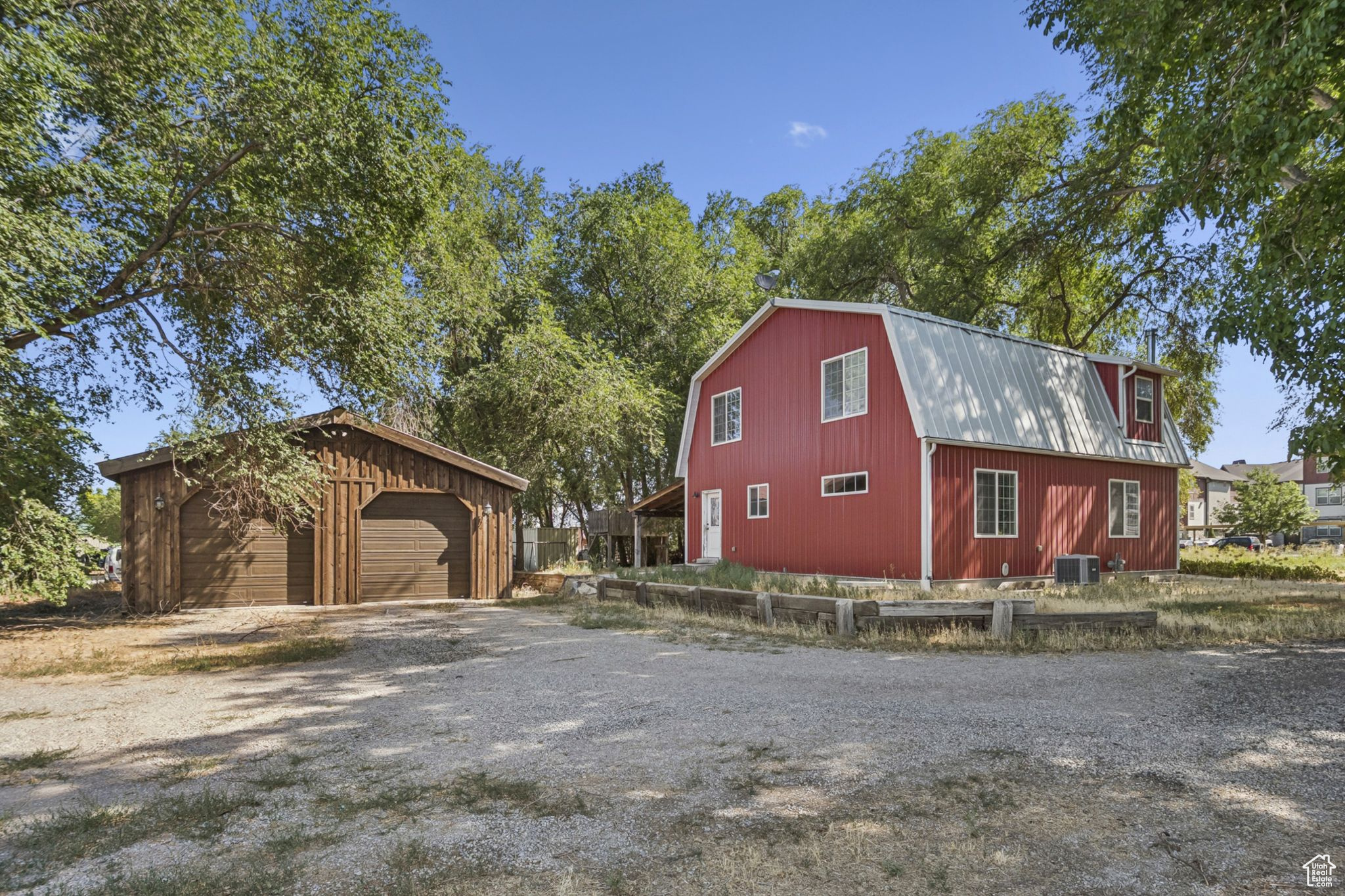 Zoned Agricultural or Industrial, this one-of-a-kind 2.6-acre property offers well and irrigation water rights and is known as "The Red Barn," one of the most unique and beautiful horse properties in Utah County. Designed as both a stunning home and a turnkey farm, it features six bedrooms, three and a half bathrooms, engineered hardwood floors, and a stylish, functional kitchen with granite island bar. The main-floor master suite makes this a forever home option, while upstairs you'll find three spacious bedrooms, including one oversized room ideal for a playroom or teen suite, plus a double vanity bathroom. The finished basement offers two additional bedrooms-one oversized and one perfect for an office-a full bath, a cozy family room with fireplace, and two storage rooms including cold storage. The outdoor space is built for enjoyment with a 460 sq ft covered patio featuring barn plank-stamped concrete, timber framing, and a metal roof, surrounded by mature shade trees, a treehouse, and plenty of space for gatherings. Horse facilities include a run-in paddock, arena, and pasture. Outbuildings include a 1,200 sq ft detached garage with two 10-ft doors, extra-high ceilings, and rough-sawn pine exterior; a 600 sq ft concrete block workshop with workbench and storage; a 240 sq ft hay shed; and a custom tack shed created from a corrugated steel silo with wood veneer interior, built-in saddle racks, and power. Located in the perfect blend of country charm and city convenience, this property is ready for your horses, livestock, and dreams. Our loss is your gain-don't miss the opportunity to make it yours .*** Listing Video Link https://youtu.be/Vg4_PUdYfsI*** Square footage figures are provided as a courtesy estimate only and were obtained from previous MLS Listing Buyer is advised to obtain an independent measurement.