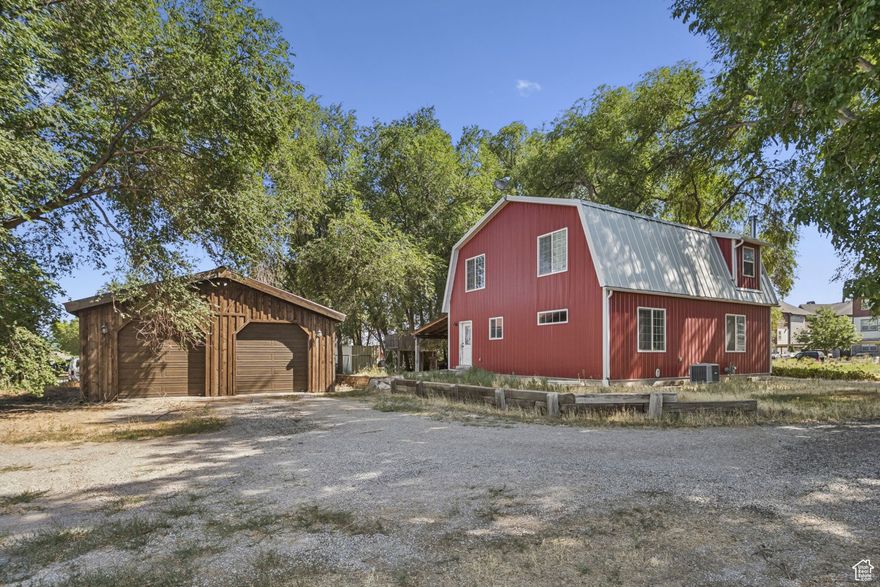 Zoned Agricultural or Industrial, this one-of-a-kind 2.6-acre property offers well and irrigation water rights and is known as "The Red Barn," one of the most unique and beautiful horse properties in Utah County. Designed as both a stunning home and a turnkey farm, it features six bedrooms, three and a half bathrooms, engineered hardwood floors, and a stylish, functional kitchen with granite island bar. The main-floor master suite makes this a forever home option, while upstairs you'll find three spacious bedrooms, including one oversized room ideal for a playroom or teen suite, plus a double vanity bathroom. The finished basement offers two additional bedrooms-one oversized and one perfect for an office-a full bath, a cozy family room with fireplace, and two storage rooms including cold storage.  The outdoor space is built for enjoyment with a 460 sq ft covered patio featuring barn plank-stamped concrete, timber framing, and a metal roof, surrounded by mature shade trees, a treehouse, and plenty of space for gatherings. Horse facilities include a run-in paddock, arena, and pasture. Outbuildings include a 1,200 sq ft detached garage with two 10-ft doors, extra-high ceilings, and rough-sawn pine exterior; a 600 sq ft concrete block workshop with workbench and storage; a 240 sq ft hay shed; and a custom tack shed created from a corrugated steel silo with wood veneer interior, built-in saddle racks, and power.  Located in the perfect blend of country charm and city convenience, this property is ready for your horses, livestock, and dreams. Our loss is your gain-don't miss the opportunity to make it yours .*** Listing Video Link https://youtu.be/Vg4_PUdYfsI***    Square footage figures are provided as a courtesy estimate only and were obtained from previous MLS Listing  Buyer is advised to obtain an independent measurement.