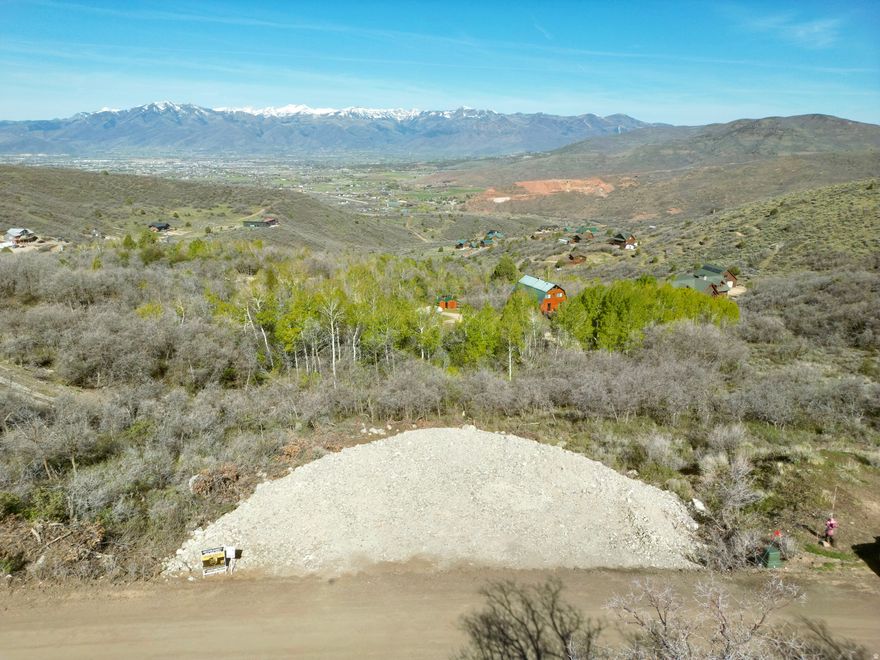 Perched above the valley in the highly sought after Timberlakes community, this incredible lot delivers the kind of views people come to the mountains for panoramic, unobstructed vistas of Mount Timpanogos and the entire Heber Valley. Perc test approved and ready to start the building process. This is the ideal setting to build your dream mountain home, offering the perfect balance of privacy, natural beauty, and accessibility.The groundwork has already been started for you, with $30,000 invested in a rock and gravel for the driveway and garage area, plus an approved perc test in place making this a truly build ready opportunity. If you've been waiting for the right lot with the right views in Timberlakes, this is it.