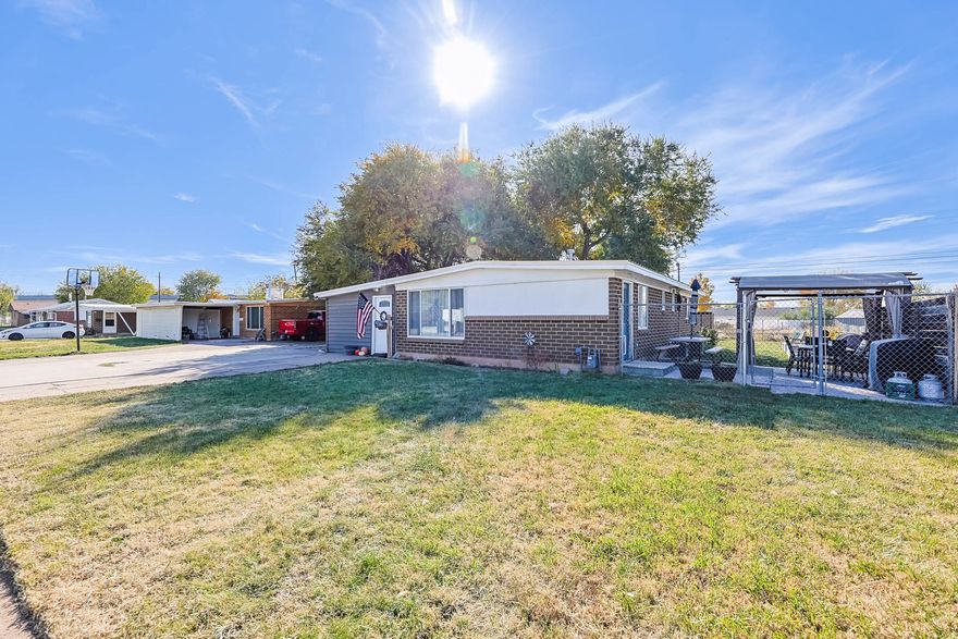 Welcome to this cute Clearfield rambler offering easy single-level living and new flooring throughout the home. The layout includes a large family room with a beautiful brick fireplace, a spacious dining room with great natural light, and a kitchen with granite countertops and plenty of cabinet space. You'll also find three bedrooms, a full bath, and a bonus room perfect for an office or flex space. The fully fenced backyard is a huge bonus with mature trees, raised garden beds, a large patio, sheds that stay, and an included pergola-creating a great setup for outdoor enjoyment. Convenient location close to I-15, Hill AFB, shopping, and everyday amenities. Well cared for and move-in ready.