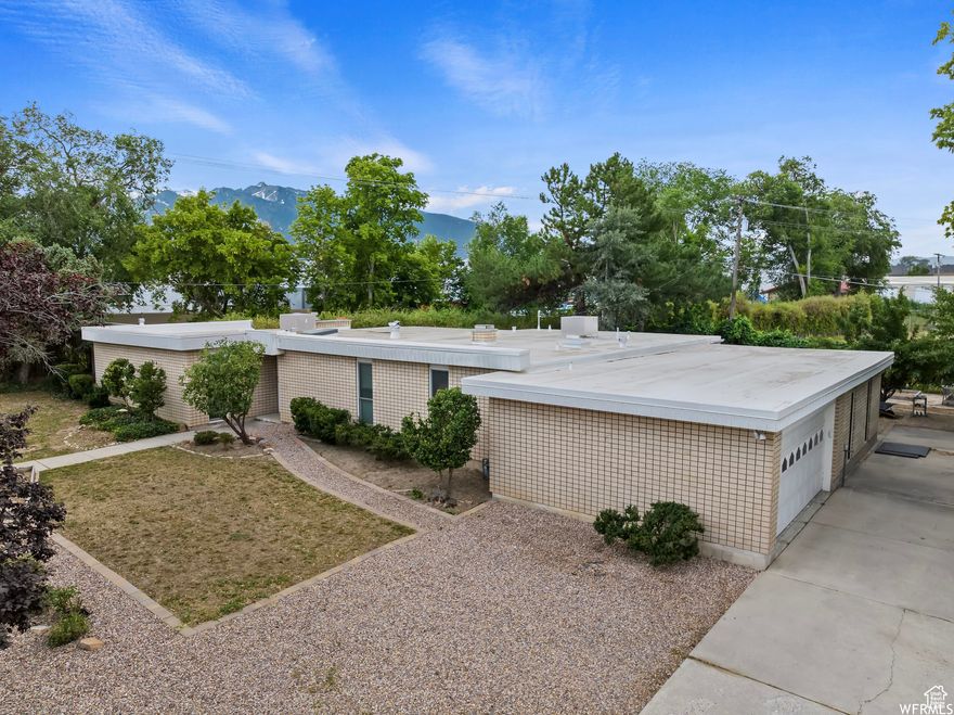 Welcome to your dream home in Midvale! Nestled in a desirable location right next to Copperview Elementary, this is single level living with a cool mid-century mod vibe at it's best! As you step inside, you'll be greeted by an inviting living room with a gorgeous rock fireplace, creating a cozy ambiance for relaxing evenings. The abundance of natural light streaming through large windows creates a warm and inviting atmosphere throughout the home. The master bedroom is a true retreat, featuring another fireplace, a large walk-in custom closet, and leads to the outside providing another private sanctuary. Fitness enthusiasts will appreciate the convenience of having your own home gym too.  This home has so much to offer-- don't miss this one!