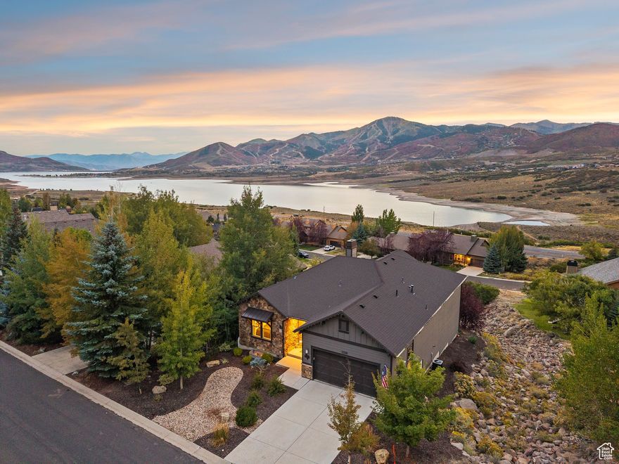 Set high on the slopes of the coveted Deer Mountain community, this 4,400-square-foot mountain contemporary home is designed to bring the outdoors in while offering unmatched comfort and privacy. With 5 bedrooms and 5 bathrooms, the residence balances striking modern architecture with warm mountain textures, creating a retreat that feels both elevated and welcoming.  From the moment you step inside, you're greeted by sweeping, panoramic views of Jordanelle Reservoir and the Wasatch Back. Expansive windows capture the lake and mountain vistas from nearly every room, while HOA-owned open space below the property guarantees these views will remain forever protected.  The open-concept great room serves as the heart of the home, where soaring ceilings, clean lines, and natural finishes create a sense of calm sophistication. A gourmet kitchen anchors the space, perfect for both casual family gatherings and larger-scale entertaining. Multiple decks extend the living experience outdoors, inviting you to savor sunrises over the lake, alpenglow on the peaks, and star-filled nights in crisp mountain air.  Five spacious bedroom suites-including a serene primary retreat-offer plenty of room for family and guests. Each space is designed with privacy and comfort in mind, while thoughtfully placed windows ensure that the views are never far away. The home's layout allows for both connection and retreat, making it equally suited for year-round living or as a second-home getaway.  Life at Deer Mountain is about more than the home itself-it's about access and lifestyle. Just minutes from world-class skiing at Deer Valley and Park City Mountain, as well as historic Main Street dining and entertainment, the location is perfectly positioned for both adventure and relaxation. In summer, the Jordanelle Reservoir below offers boating, paddle boarding, fishing, and waterfront fun, while hiking and biking trails connect you to nature in every direction.  12335 Deer Mountain Blvd. isn't just a home-it's a year-round sanctuary where design, setting, and lifestyle come together seamlessly.