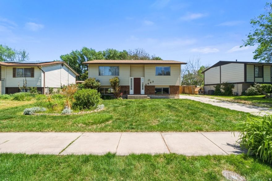 *** No showings until Open House on Saturday, 16th from 11 to 3 *** if you have been looking for a home with real value and room to make it your own, this one deserves your attention. This 4-bedroom, 2-bathroom split-entry in Roy is honestly priced for a buyer who appreciates potential and is ready to add some personal touches. The upper level flows nicely from the living room into the kitchen and dining area, with a sliding glass door leading out to the back deck. The kitchen has seen solid updates including dark distressed cabinetry, subway tile backsplash, butcher block countertops, and a full stainless steel appliance package. Stacked LG washer and dryer are included too, so the big stuff is already taken care of. Every bedroom features carpet and a ceiling fan. The lower level adds serious square footage with a large family room, two additional bedrooms, and a full utility room with a Lennox furnace and Rheem water heater.  The backyard is a genuine standout with a large fully fenced yard, mature shade trees, raised garden beds, a storage shed, a swing set, and a deck off the kitchen made for relaxing and entertaining. The value is real here! Come see it before someone else does.
