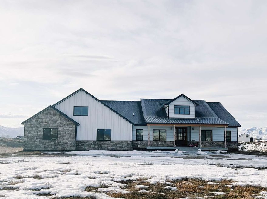 Gorgeous custom home on 40 acres with a creek, located right outside of Malad, Idaho. (Additional 40 acre joined lot also available for purchase) Located in a beautiful, secluded valley, surrounded by mountains, this property is a dream for outdoor enthusiasts. Built in 2021, this 6,800 square foot custom-built residence offers 5,600 square feet of finished space, with an additional 1,200 square foot unfinished room above the garage. There's a total of 7 bedrooms, 5 full bathrooms, 2 half baths, and 2 living areas, one upstairs and one downstairs. The master suite has a large walk-in shower, a soaking tub, and a 17x20 (350 sq feet) master closet with washer/dryer hookups, a customized folding table/jewelry box, custom counters, and full walls of cabinet, dressers, and shoe shelves. Also includes a large shop (with an apartment) that is 3600 square foot and 45x80 in dimension. It has its own septic system, propane, washer/dryer hookups, and full RV hookup inside.