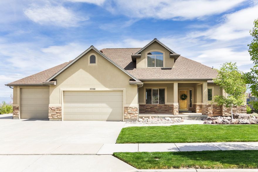 Welcome home to 5338 Emmeline Drive, where soaring vaulted ceilings and expansive windows create a light-filled interior, perfectly framing the sweeping mountain views. The main level is thoughtfully designed for both everyday living and entertaining, featuring an open-concept layout that seamlessly connects the living room, kitchen, and dining area. Step onto the deck to enjoy the morning sun or dining in the evening. The main-floor primary suite offers a private retreat, complete with a beautifully renovated bathroom with a walk-in shower and a separate soaking tub, plus a spacious walk-in closet. Upstairs you will find two additional bedrooms, a full bath, and a versatile loft providing flexible living space perfect for a home office, lounge, or creative studio. The walk-out lower level expands the home's possibilities with two additional bedrooms, a generous family room, semi-formal dining space, another laundry area and a kitchenette making it ideal for guests or multigenerational living. Additional features include a dedicated workout area and a cold storage room. Convenience meets luxury with main-level laundry and carefully curated upgrades throughout, including a reverse osmosis water system, new carpet and newly painted Martin garage doors. Additional highlights include RV parking, a utility sink in the garage, a new roof (2025), and HVAC system (2021). Outdoors, the property offers exceptional privacy with no neighbors on three sides. Enjoy a beautifully landscaped yard with a flagstone patio, lush lawn, perennial gardens with blooming irises, and a plum tree. Wildlife sightings, including deer, enhance the serene, natural setting. Located just half a block from Herriman's extensive trail network, this home offers immediate access to miles of hiking and mountain biking - bringing together luxury living and outdoor lifestyle in one exceptional property.