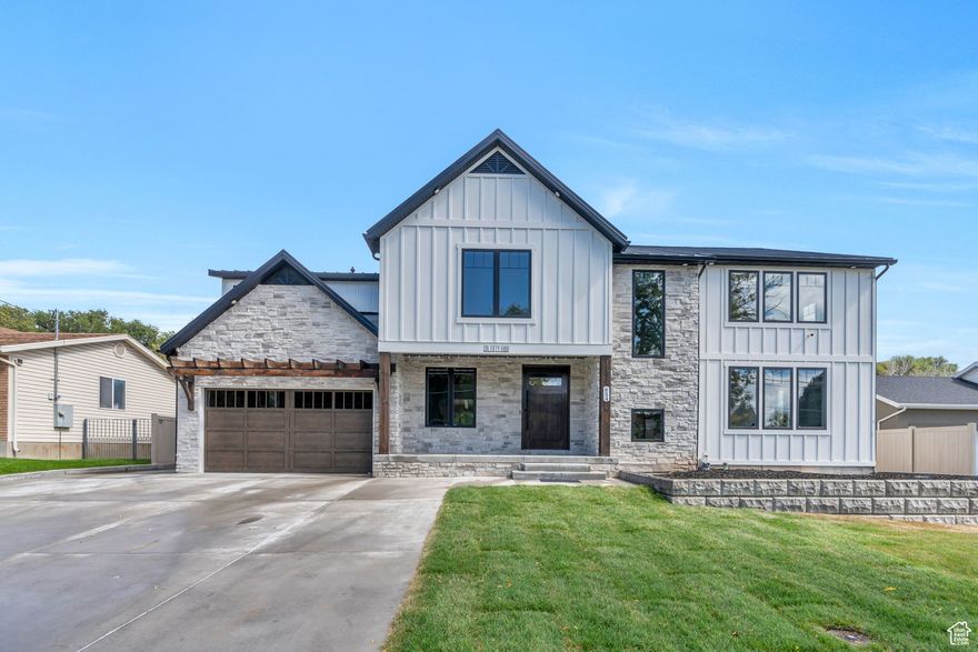 Experience modern luxury in this custom-built residence nestled in the heart of American Fork, Utah. This thoughtfully designed home offers a harmonious blend of elegance and functionality, perfect for discerning homeowners seeking comfort and style. Interior Highlights: Authentic Wood Flooring: Adds warmth and character throughout the main living areas. Spacious Living Room: Features a large mantle surrounding the fireplace, creating a cozy ambiance. Formal Dining Room: Ideal for hosting gatherings and special occasions. Main-Level Primary Suite: Provides convenience and privacy for homeowners. Upper Level: Boasts 3 bedrooms, including a Jack-and-Jill bathroom, an additional full bathroom, a generous bonus room, and a laundry area with washer and dryer. Versatile Basement: Offers a separate living space with three bedrooms, two bathrooms, a gym, and a secure gun room Exterior Features: Unfinished Yard: Presents a blank canvas to design your dream outdoor oasis, with ample space for gardens, patios, recreational areas, or even a pool. Covered Patio: Equipped with cooking amenities and a fenced backyard, it's perfect for entertaining and enjoying Utah's beautiful seasons. Garage/Shop Space: Provides additional storage and workspace for projects or hobbies. Note: Price and square footage figures are based on a recent professional appraisal. For more information or to schedule a private tour,