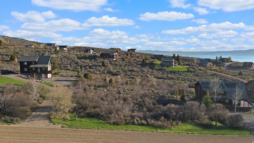 Nestled in the scenic community of Bear Lake West, this stunning building lot offers a rare opportunity to create your dream retreat in one of Idaho's most picturesque locations. Situated close to the golf course, the lot provides breathtaking views of the turquoise waters of Bear Lake and is surrounded by majestic mountain landscapes. Whether you're planning a vacation home or a year-round residence, the natural beauty and serene setting offer the perfect backdrop for peaceful living and outdoor adventure. Residents of Bear Lake West enjoy a wealth of amenities, including a clubhouse with a restaurant, pool, hot tubs, tennis courts, and pickleball courts. The community also features a well-maintained golf course and private beach access, giving you endless opportunities for recreation. Just minutes away, you'll find the Bear Lake Marina for boating and water sports, and in the winter, you're a short drive from the slopes of Beaver Mountain Ski Resort. This lot offers not just a place to build, but a lifestyle of comfort, convenience, and outdoor enjoyment. Buyer to verify all information.