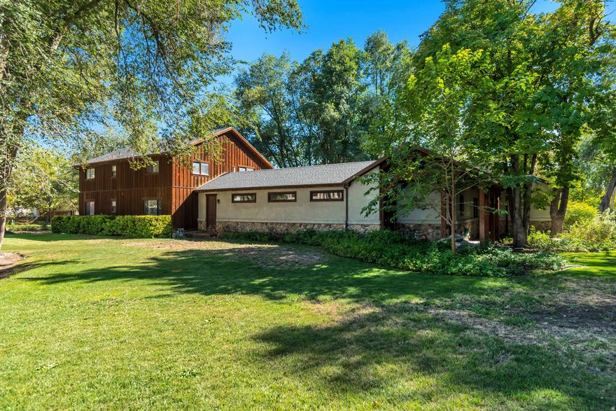 Tucked away on 3.10 secluded acres, this remarkable property offers both privacy and luxury. A mature tree-lined driveway leads to a beautifully landscaped oasis featuring a courtyard-style backyard, custom pool with spa-like ambiance, and an in-ground hot tub and waterfall. Inside, vaulted ceilings and a thoughtfully designed floor plan create an inviting atmosphere. The gourmet kitchen is complemented by a screened-in patio with an outdoor grill and wet bar perfect for entertaining. The main-floor master retreat offers direct access to the pool and spa, creating the ultimate private escape. Additional amenities include a large home gym, outdoor fireplace and patio, firepit, horseshoe and shuffleboard areas, basketball standard, and expansive parking for all your toys and equipment. A detached oversized garage and workshop, is fully equipped with everything you could need including 220v power, a dust collection system, office and half bath. In addition to the workshop you'll find a 3-bedroom, 2-bathroom, accessory apartment providing the perfect guest retreat or potential rental income. Reach out today to make this property with endless opportunity, your own. Buyer/Buyer's Agent to verify all info.