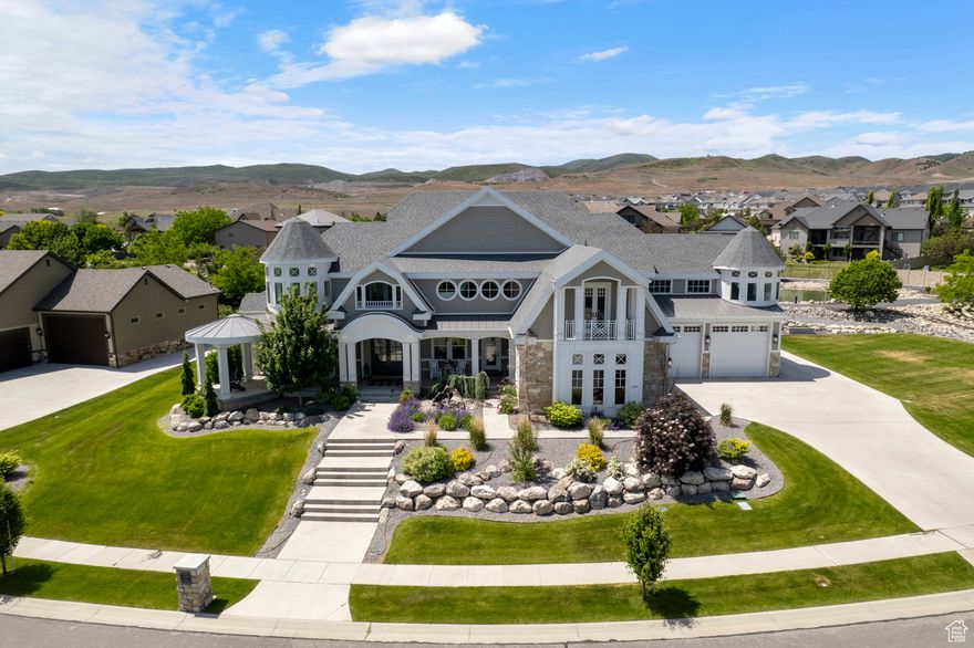 This South Hampton-style house boasts a charming and beautiful exterior, offering stunning views of mountains, ponds, and a picturesque neighborhood. This impressive estate showcases exceptional craftsmanship and attention to detail at every turn. The expansive front porch provides a warm welcome and ample space for relaxation, with its water feature, as does the back porch. The grand entrance of this home features a sensible flow, with a winding staircase from the top floor to the basement located on one side of the house, and another staircase off the kitchen leading upstairs. The abundant natural light streaming through the expansive commercial windows in the living room and kitchen is truly breathtaking. The home features a gourmet kitchen with a pantry, soaring ceilings with natural wood moldings, a grand entrance, and a luxurious master suite on the main floor. This estate exudes luxury, boasting exquisite chandeliers, lighting, and fixtures throughout. Additionally, the estate is equipped with an indoor basketball court, a state-of-the-art gym, an indoor slide conveniently hidden in the walls, a Lego loft, a vibrant bounce/climbing room (a child's dream), balconies off two guest bedrooms, a sprawling theater room, a walkout basement, a wet bar, and an inground trampoline, outdoor gas fireplace. The backyard is enhanced by a beautifully crafted man-made stream that runs through the landscape, with water gently cascading over rocks. This artistic water feature adds a touch of nature to the outdoor space, creating a serene and peaceful atmosphere.  Nestled within the sought-after Falls at Boulden Ridge subdivision, the property boasts a spacious lot overlooking a tranquil pond and a winding walking trail, with the potential for a stunning swimming pool addition. It is truly a place to call home. **Seller is open to a seller finance. Call for details.