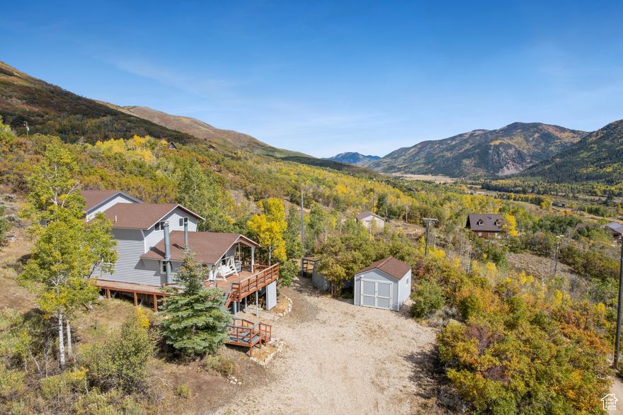 Perched atop 2.3 pristine acres just east of Oakley, this stunning 2,220 square foot cabin offers breathtaking "top of the world" views from every angle. Wake up to sunrise over Thousand Peaks Ranch from your east-facing deck, then end each day watching spectacular sunsets paint the Wasatch Back from your front porch. The thoughtfully designed outdoor space features secluded fire pits and terraced yards perfect for children's play, all nestled in complete privacy. Inside, you'll discover a spacious layout with two inviting living areas, each anchored by its own cozy wood-burning stove, while the well-appointed kitchen with stunning down-canyon views seamlessly connects both living spaces. The cabin features three comfortable bedrooms- one on the main floor and two lofted for maximum privacy-plus one full bathroom. The unfinished basement presents endless possibilities, already plumbed for an additional bathroom with framing and electrical work partially complete, and with its own entrance and independent heating source, it's ready for your vision. Located in the seasonally accessible Beaver Springs Ranch community, you'll enjoy Weber River access and limitless outdoor adventures, with Smith and Morehouse Reservoir and National Forest lands just moments away, putting world-class recreation right at your doorstep.   Square footage figures are provided as a courtesy estimate only.  Buyer is advised to obtain an independent measurement.