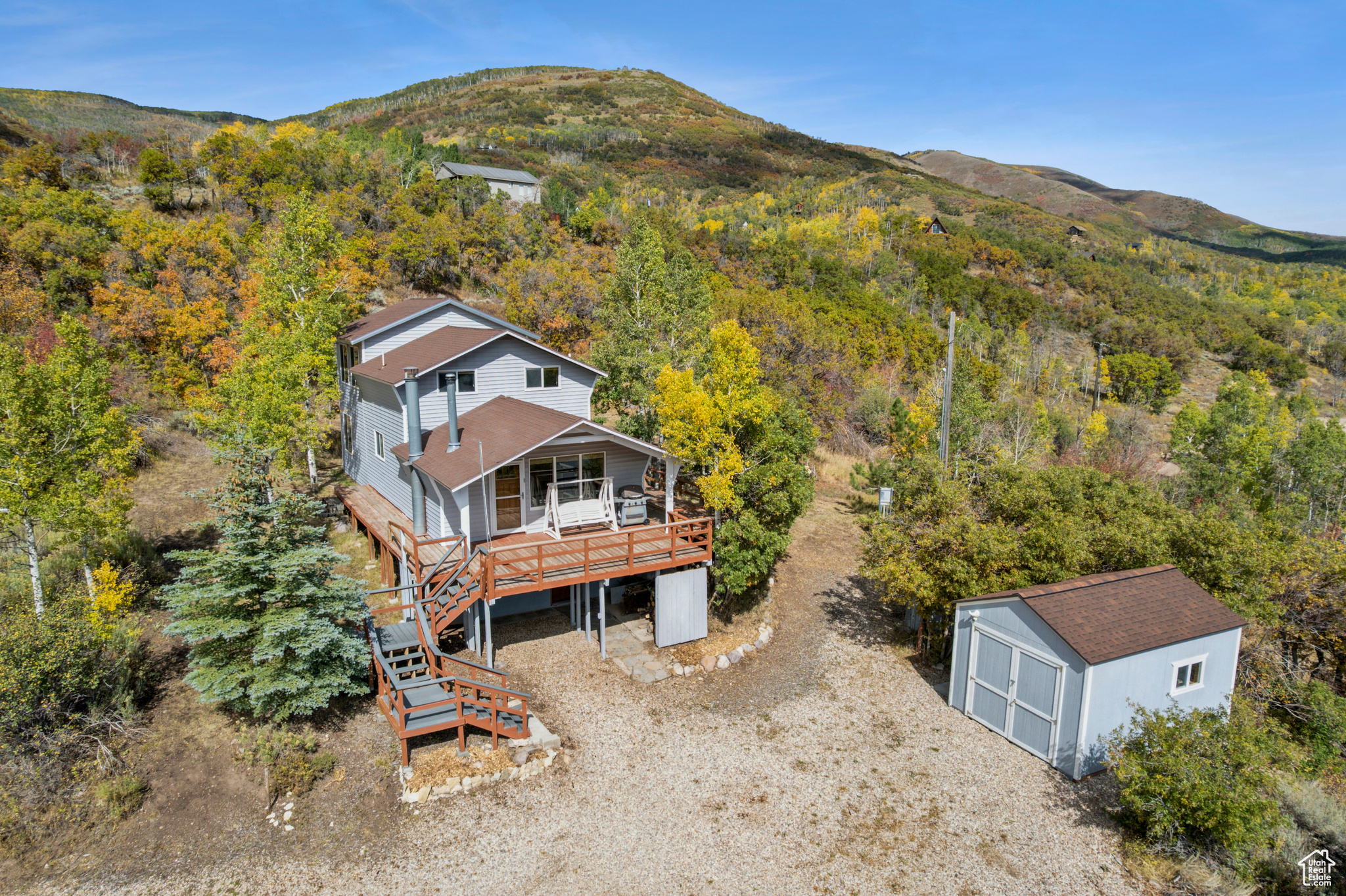 Perched atop 2.3 pristine acres just east of Oakley, this stunning 2,220 square foot cabin offers breathtaking "top of the world" views from every angle. Wake up to sunrise over Thousand Peaks Ranch from your east-facing deck, then end each day watching spectacular sunsets paint the Wasatch Back from your front porch. The thoughtfully designed outdoor space features secluded fire pits and terraced yards perfect for children's play, all nestled in complete privacy. Inside, you'll discover a spacious layout with two inviting living areas, each anchored by its own cozy wood-burning stove, while the well-appointed kitchen with stunning down-canyon views seamlessly connects both living spaces. The cabin features three comfortable bedrooms- one on the main floor and two lofted for maximum privacy-plus one full bathroom. The unfinished basement presents endless possibilities, already plumbed for an additional bathroom with framing and electrical work partially complete, and with its own entrance and independent heating source, it's ready for your vision. Located in the seasonally accessible Beaver Springs Ranch community, you'll enjoy Weber River access and limitless outdoor adventures, with Smith and Morehouse Reservoir and National Forest lands just moments away, putting world-class recreation right at your doorstep. Square footage figures are provided as a courtesy estimate only. Buyer is advised to obtain an independent measurement.