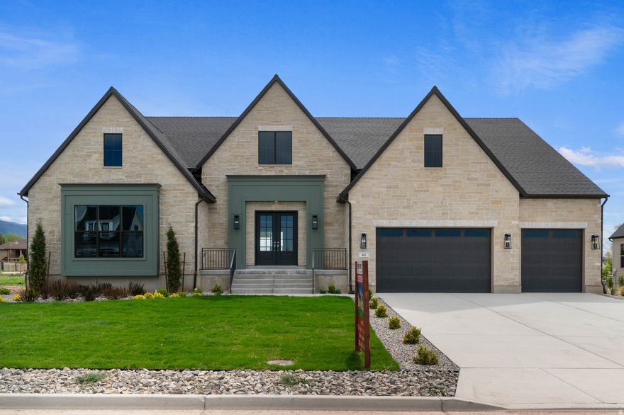 Experience refined living in a great Kaysville community! This beautiful Butler Traditional home is meticulously designed to fit the pickiest buyers needs! As you walk into the entry and lead into the great room you will be impressed with the stunning coffered ceilings and size and space of the home. Also featured is a large chef's kitchen with custom cabinets highlighted with LED lighting, quartz countertops, gorgeous full height tile backsplash and stainless steel Caf gas appliances with double ovens anchored by pendant lighting above the kitchen island. Elegant laminate hardwood, tile, and carpet flooring flows through the home. The finished 3-car garage with exit door and finished game room in the basement with 9 foot foundation walls provides ample extra space. Other luxury upgrades include a water conditioner system, USB outlet in the owner's bedroom, gas line to the dryer, Christmas and flood light packages, while you can cozy up with gas log fireplaces in the great room, office, and owner's suite. The owner's bedroom shines with decorative ceiling beams, a ceiling fan, and an indulgent Tori tub in the spa-like bathroom featuring tile surrounds and polished nickel hardware. Accented with textured walls, 2-tone paint, Camden wainscoting in the office, and finished with Roosevelt base and casing, this home blends timeless charm with modern comfort. Don't miss out on this home that offers it all!