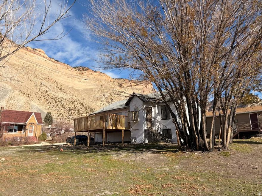 Large property on the corner with .44 acres. Basement with game room, 3 bedroom's 1 bd downstairs, with rough plumb for a 2nd bth. New flooring, fireplace, & land. Updated price! Beautiful place to live, great small town, amazing views, separate entrance