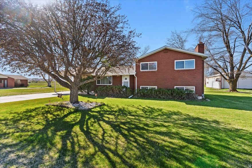 Horse property on a 1.25 acre lot with a 25' x 48' detached garage with 3 doors. This home offers country living at its finest with beautiful mountain views. The home features 3 bedrooms, newer kitchen cabinets and flooring, and 1.5 bathrooms, plus a large formal living room and a spacious basement family room with a fireplace. The home also has newer windows, furnace, A/C, water heater, and roof within the past 10 years.  Outside you'll find a fully fenced pasture with water access for animals, a  water share, and plenty of space for parking, equipment, or recreational toys.  Trust sale. Seller has never lived in the home, so no seller property disclosure will be provided.