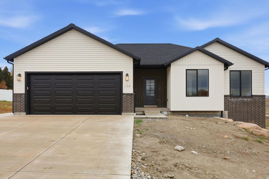 Charming New Build with Valley Views  258 E 250 S Richmond, Utah | 3 Bed | 2 Bath | 2-Car Garage | .31 Acre Lot   Welcome to this stunning 2025-built home located at the end of a quiet cul-de-sac in a brand-new neighborhood in beautiful Richmond, Utah. Designed for both comfort and style, this 3-bedroom, 2-bath home offers 1,374 sq ft on the main floor with an additional 1,357 sq ft of walk-out basement space ready to finish-ideal for future expansion, a mother-in-law suite, or short/long-term rental income.  Interior Highlights  Bright, open-concept living with Luxury Vinyl Plank (LVP) flooring, plush carpet, and stylish tile  Chef's kitchen featuring painted cabinets, granite countertops, Frigidaire appliances, and a walk-in pantry  Spacious master suite with en-suite bath and walk-in closet  Modern heating and A/C systems for year-round comfort  Electric washer/dryer hookups in the dedicated laundry room  Exterior Features  Brick and vinyl siding with modern black windows  2-car attached garage  .31-acre lot with beautiful valley views  Back patio with BBQ gas stub  Walk-out basement offers flexibility and potential   Location Perks  Quiet and family-friendly cul-de-sac  3-minute drive to parks, grocery stores, gas stations, and restaurants  Zoned for highly rated schools:     - White Pine Elementary     - North Cache Middle School     - Sky View High School  Why You'll Love It Whether you're looking for a peaceful place to raise a family or an investment opportunity with basement rental potential, this home checks every box. The quiet street, scenic views, and proximity to daily essentials make it the perfect blend of rural charm and modern convenience.