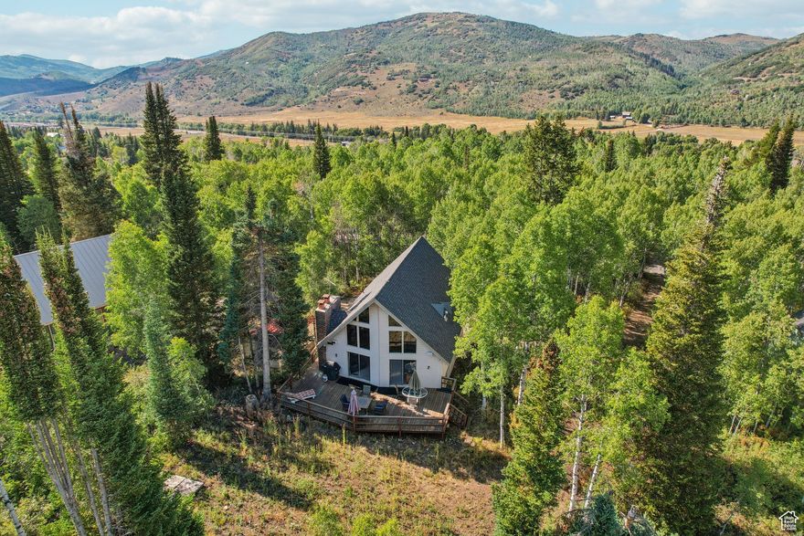 Discover this incredible Oakley home, perfectly situated on a spacious 0.61-acre lot within the desirable gated community of Pine Mountain, offering breathtaking mountain and valley views and an unparalleled sense of tranquility. The spacious two-story home provides 3,500 square feet of living space, including a 100% finished walkout basement. Beautiful, large windows at the front of the home fill the space with natural light. The functional layout features four bedrooms, with the primary suite conveniently located on the main floor and featuring its own gas log fireplace. A second gas log fireplace warms the living room, perfect for cozy evenings. Enjoy the stunning scenery from the secluded backyard deck, or take advantage of the community's exclusive access to hiking, biking, and horse trails, along with a playground, picnic area, and basketball court. Equipped with modern efficiencies like central air conditioning, a detached garage, and RV parking, there is plenty of room for all your vehicles and toys. This is a rare opportunity to own a significant piece of mountain paradise. 1 Water share cost $100 to change.