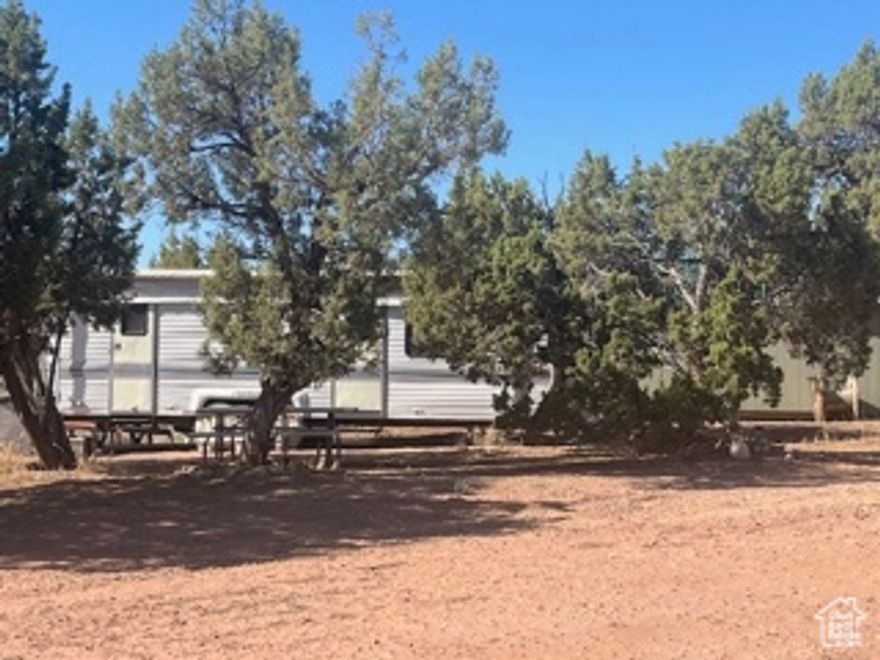 6.74 acres, 15 minutes north of Duchesne. Property has a 20'x30' covered pavilion, in the center of the RV pads. It has electricity, septic system, and a 1000 gallon water system which is pressurized. Water and power are stubbed to the RV pads. Outhouse with flushable toilet. One older camper is included in the sale. Property is only a few minutes to the High Uintah Wilderness area and Starvation area. The cabin and other RV's can be purchased separately.